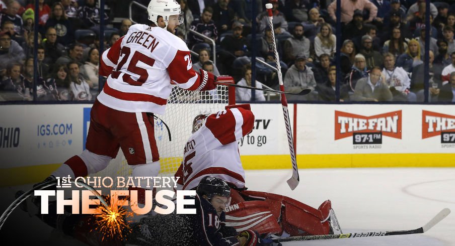 Columbus Blue Jackets center Pierre-Luc Dubois finds himself on the ice around the Detroit Red Wings net...somehow.