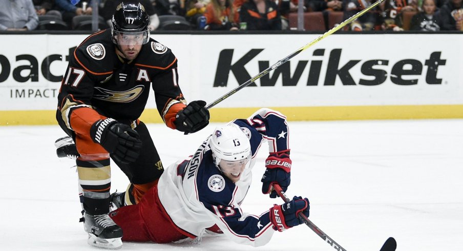 Columbus Blue Jackets' forward Cam Atkinson gets tripped up fighting for a puck on Sunday night against the Anaheim Ducks.