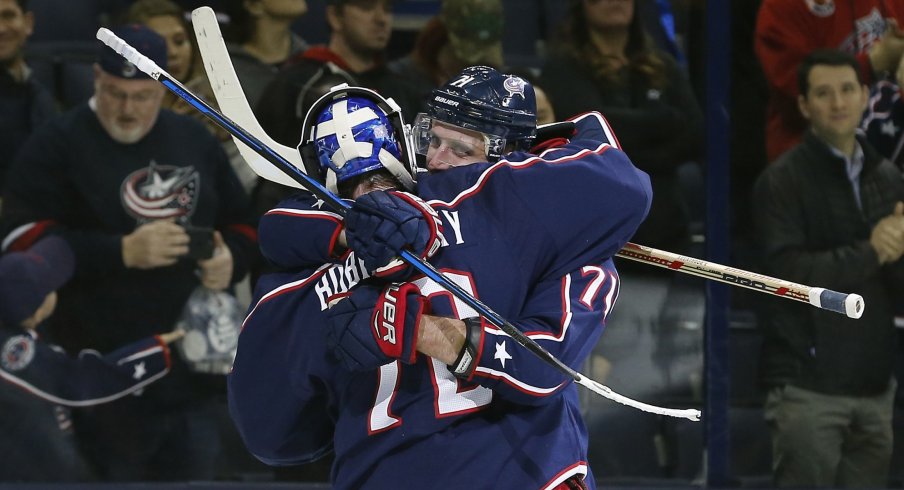 Sergei Bobrovsky and Nick Foligno embrace after a win; the Columbus Blue Jackets have 17 points in 15 games but are still at the top of their division.