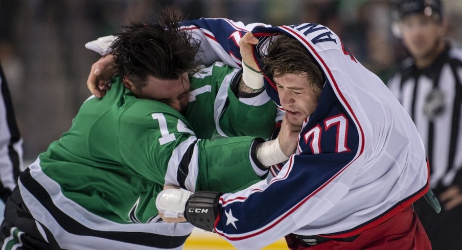 Jamie Benn and Josh Anderson fight early during the Blue Jackets and Stars game.