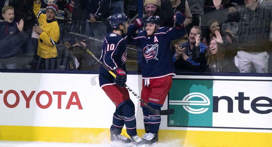 Cam Atkinson and Alexander Wennberg celebrate scoring against the Toronto Maple Leafs