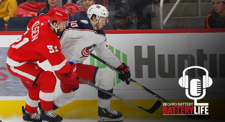 Alex Wennberg skates past Frans Nielsen in a matchup between the Detroit Red Wings and Columbus Blue Jackets