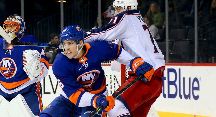 Nick Foligno battles in front of the net with Islanders defender Ryan Pulock