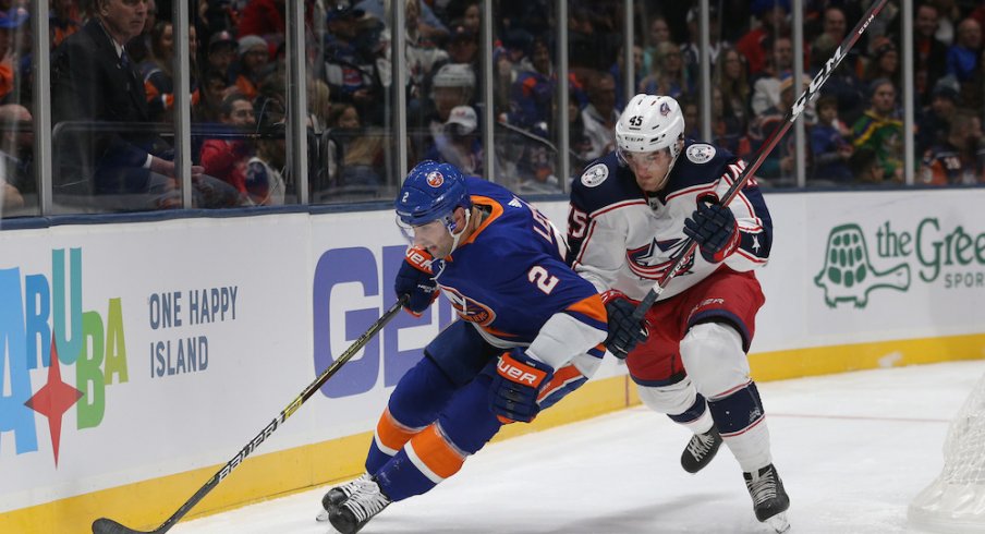 Columbus Blue Jackets center Lukas Sedlak defends against Islanders defenseman Nick Leddy at Nassau Coliseum.