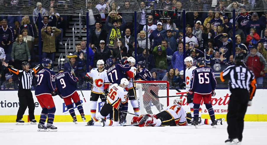 Mike Smith of the Calgary Flames makes a big save against the Blue Jackets.