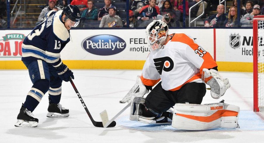 Cam Atkinson faces off against Flyers goalie Calvin Pickard