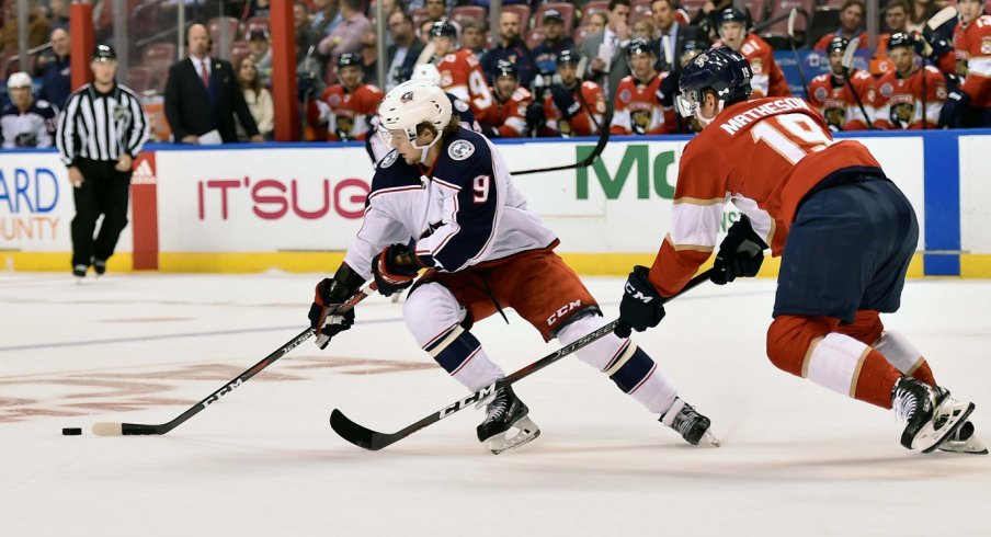 Artemi Panarin carries the puck in against Florida Panthers defensemen Mike Mathenson