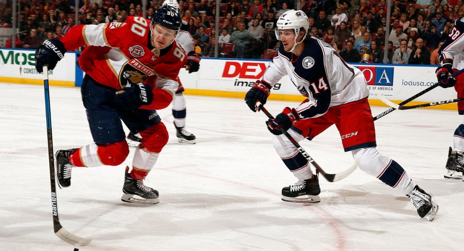 Dean Kukan fights for the puck for the Columbus Blue Jackets in a 4-3 overtime victory against the Florida Panthers.