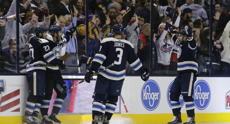 Ryan Murray Seth Jones and Nick Foligno celebrate with Boone Jenner after scoring against the Nashville Predators