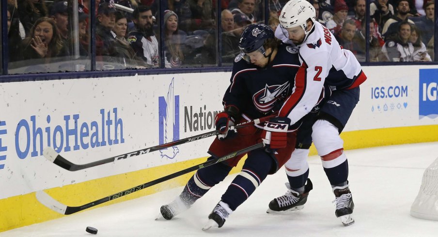 Artemi Panarin battles for position with Matt Niskanen