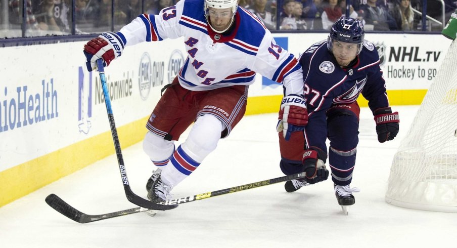 Ryan Murray fights to get the puck back from Kevin Hayes