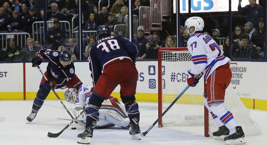 Boone Jenner waits for the puck at the front of the net.