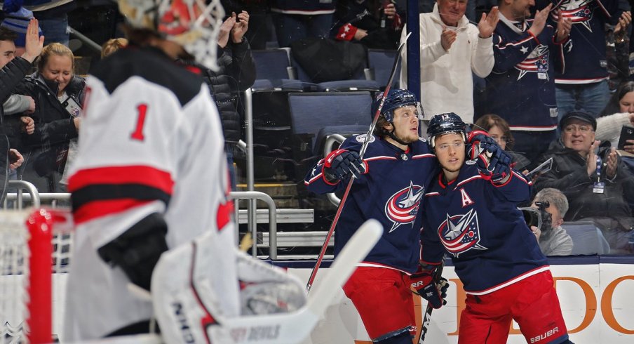 Artemi Panarin and Cam Atkinson celebrate scoring against the New Jersey Devils