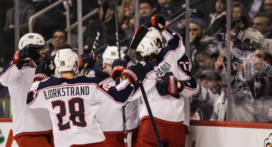 Oliver Bjorkstrand Artemi Panarin Seth Jones and Mark Letestu celebrate with Josh Anderson after his first period goal in Winnipeg.