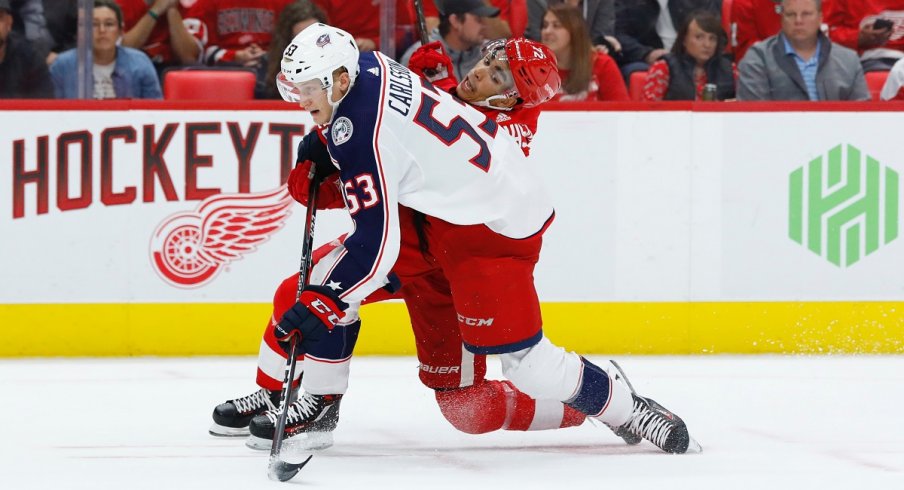 Gabriel Carlsson fights for a puck in the second period of his only NHL game this season at Little Caesars Arena