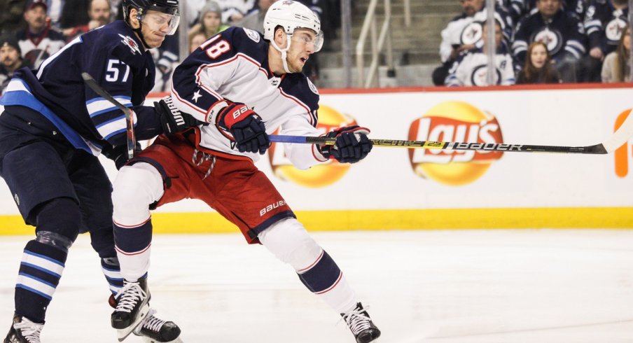 Pierre-Luc Dubois fights off the check of Winnipeg Jets defenseman Tyler Myers 