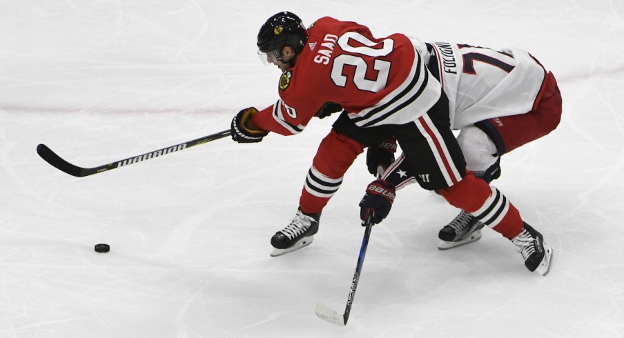 Columbus Blue Jackets captain Nick Foligno defends against Chicago Blackhawks forward Brandon Saad at United Center.