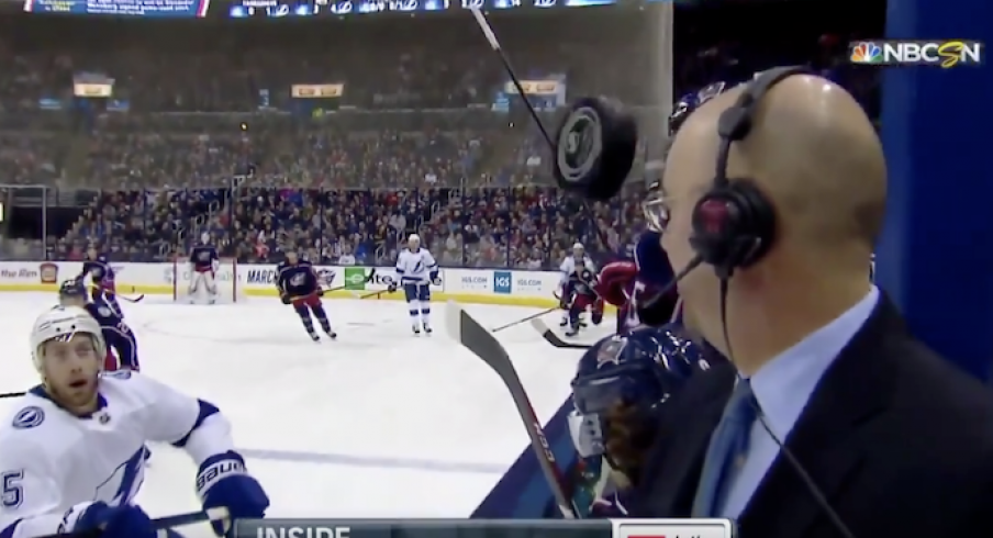 Pierre McGuire narrowly escapes disaster during Monday's game between the Blue Jackets and Lightning at Nationwide Arena.