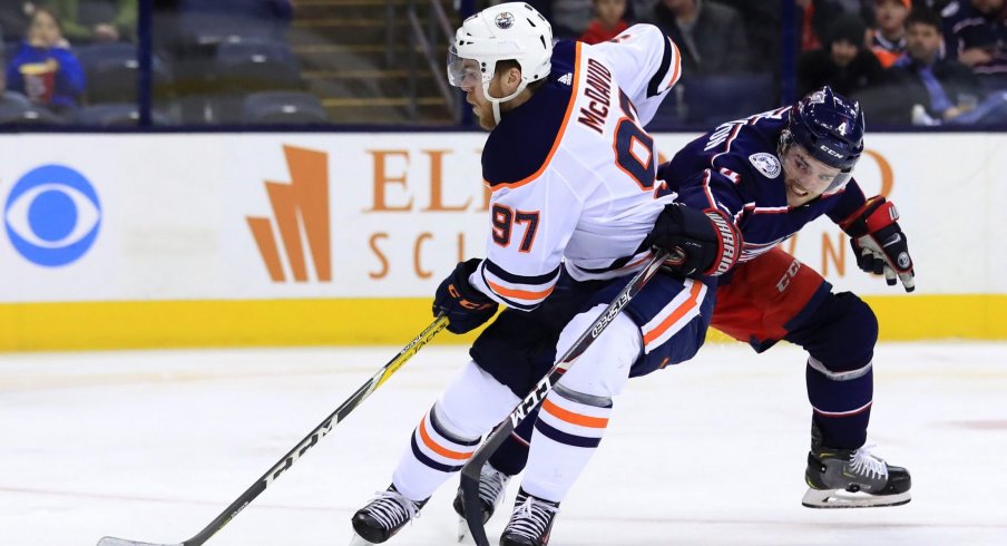 Scott Harrington struggles to contain Connor McDavid in Saturday's game for the Columbus Blue Jackets against the Edmonton Oilers