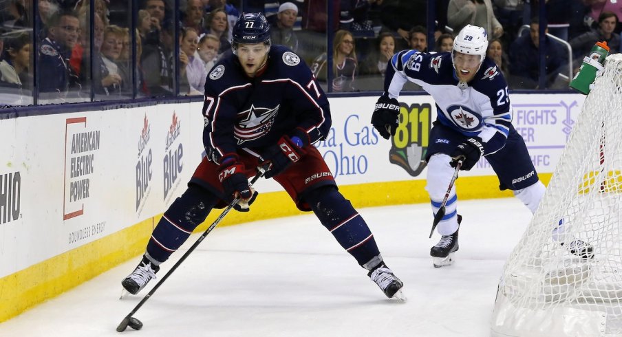 Josh Anderson skates away from Winnipeg Jet Patrik Laine during a home matchup at Nationwide Arena.