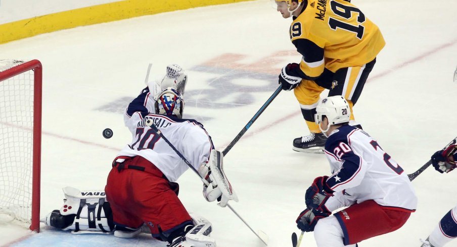 Columbus Blue Jackets goaltender Joonas Korpisalo (70) makes a save against Pittsburgh Penguins center Jared McCann (19) during the second period at PPG PAINTS Arena.