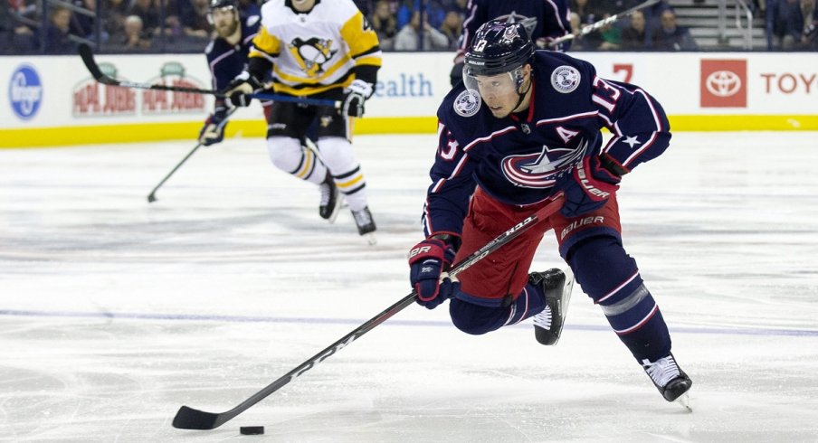 Cam Atkinson skates down the ice with the puck against the Pittsburgh Penguins at Nationwide Arena