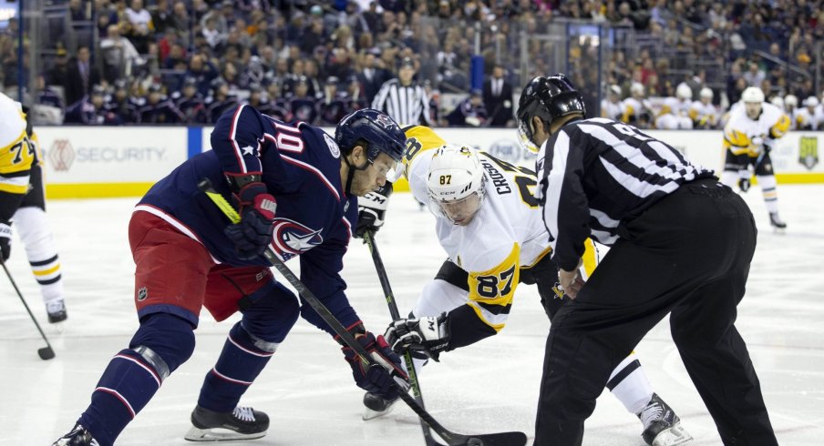 Pittsburgh Penguins center Sidney Crosby (87) and Columbus Blue Jackets center Alexander Wennberg (10) face-off during the first period at Nationwide Arena.