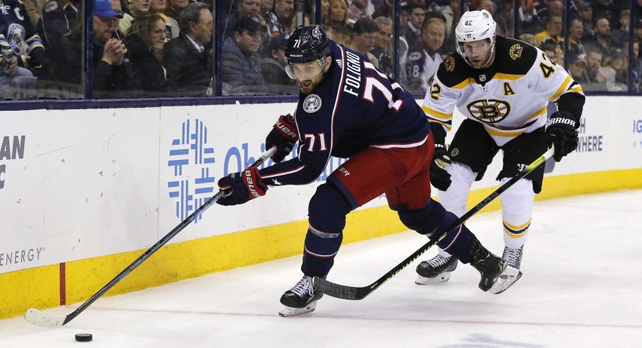 Columbus Blue Jackets left wing Nick Foligno (71) and Columbus Blue Jackets center Alexandre Sexier (42) chase down a loose puck during the second period at Nationwide Arena.