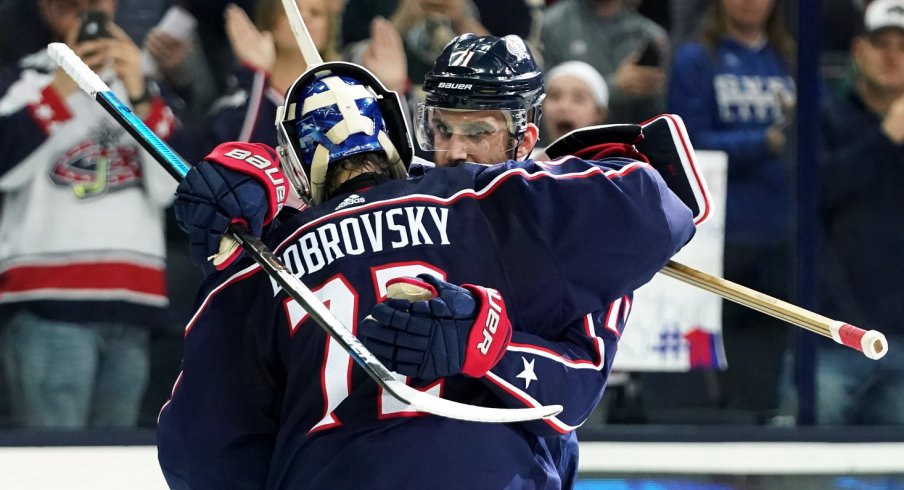 Nick Foligno and Sergei Bobrovsky hug after a win. 