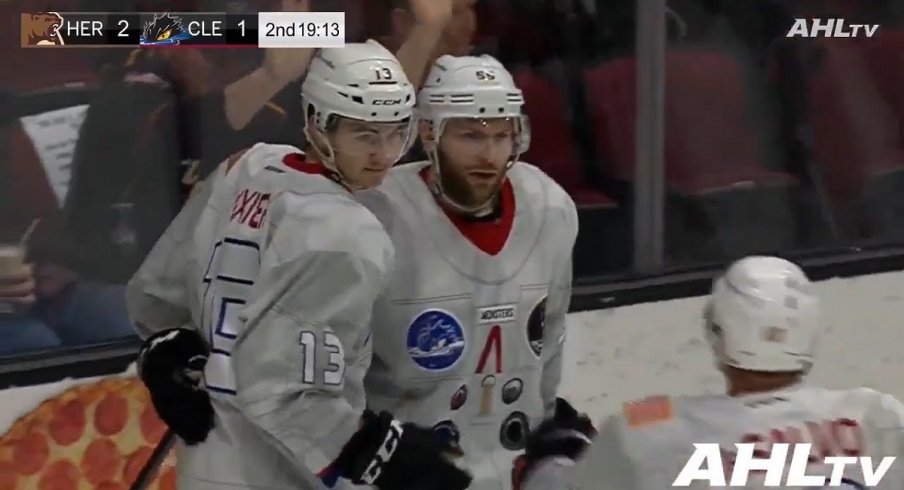 Alexandre Texier celebrates with Mark Letestu after scoring for the Cleveland Monsters