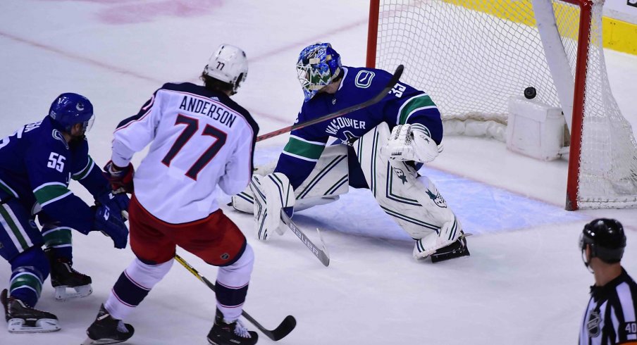 Mar 24, 2019; Vancouver, British Columbia, CAN; Columbus Blue Jackets forward Josh Anderson (77) scores a goal against Vancouver Canucks goaltender Thatcher Demko (35) and defenseman Alex Biega (55) during the third period at Rogers Arena.