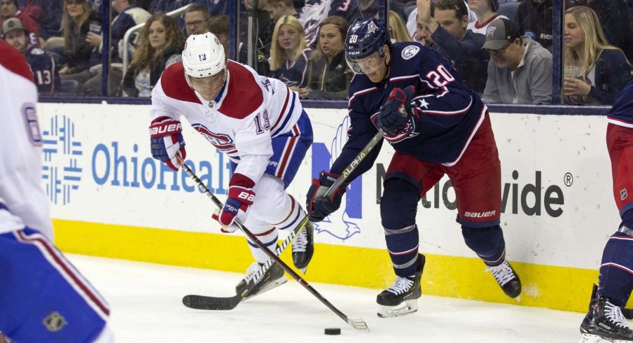 Mar 28, 2019; Columbus, OH, USA; Montreal Canadiens center Max Domi (13) and Columbus Blue Jackets center Riley Nash (20) battle for the puck during the third period at Nationwide Arena.