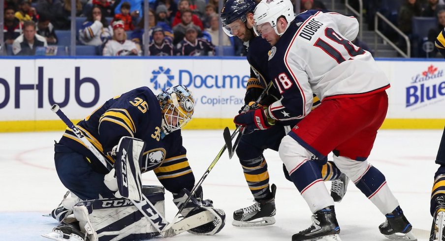 Pierre-Luc Dubois attempts to hammer the puck home against the Buffalo Sabres goaltender