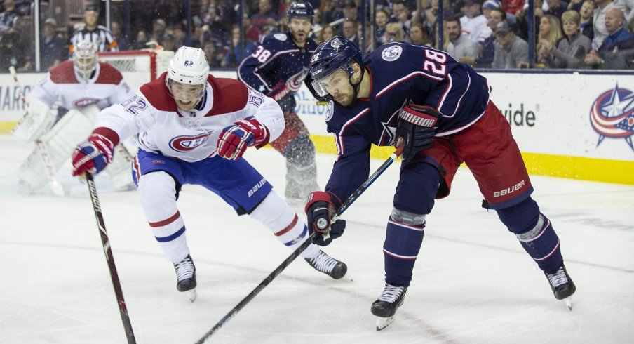 Oliver Bjorkstrand battles for the puck with Montreal Canadiens left wing Artturi Lehkonen