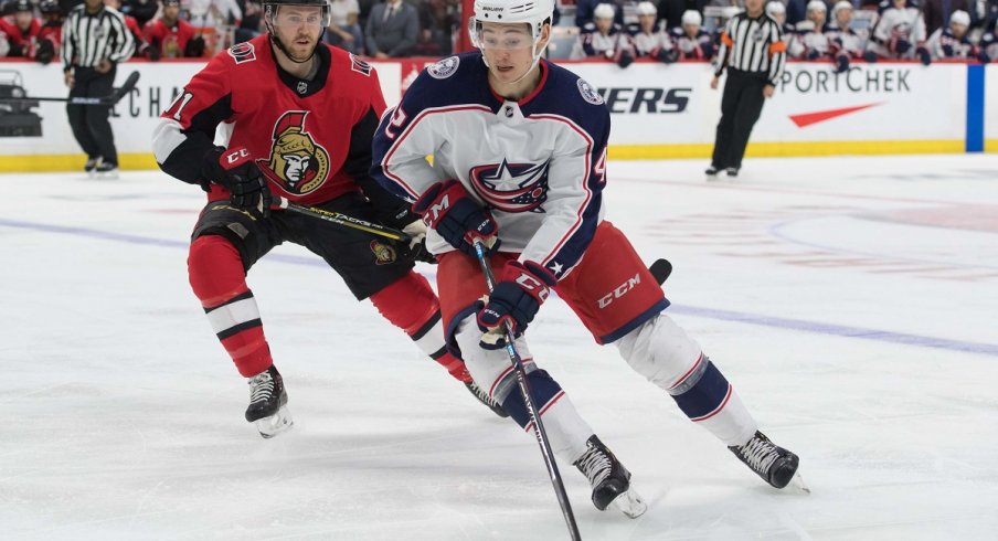 Alexandre Texier skates with the puck in front of Chris Tierney at the Canadian Tire Centre