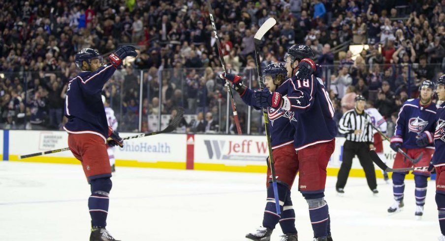 Seth Jones, Artemi Panarin and Pierre-Luc Dubois celebrate a goal scored against the New York Rangers at Nationwide Arena.