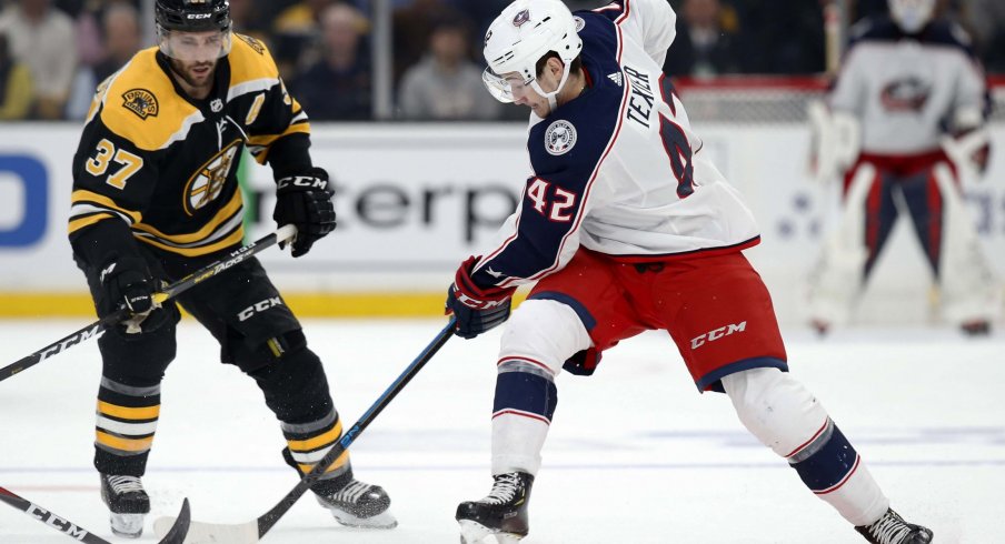 Columbus Blue Jackets center Alexandre Texier (42) battles with Boston Bruins center Patrice Bergeron (37) during the first period in game one of the second round of the 2019 Stanley Cup Playoffs at TD Garden.