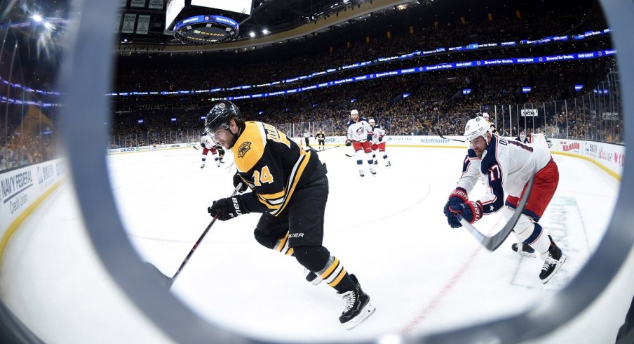  Boston Bruins left wing Jake DeBrusk (74) and Columbus Blue Jackets center Brandon Dubinsky (17) chase after the puck during the second period in game two of the second round of the 2019 Stanley Cup Playoffs at TD Garden