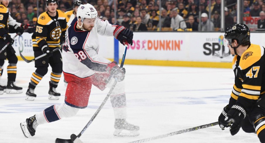 Apr 27, 2019; Boston, MA, USA; Columbus Blue Jackets right wing Oliver Bjorkstrand (28) shoots the puck while Boston Bruins defenseman Torey Krug (47) defends during the first period in game two of the second round of the 2019 Stanley Cup Playoffs at TD Garden.