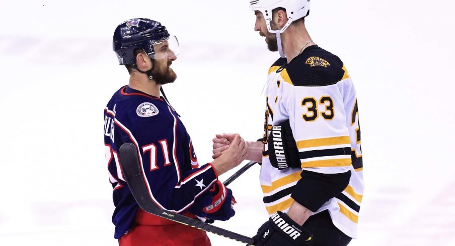 Nick Foligno shakes hands with Boston Bruins defenseman Zdeno Chara