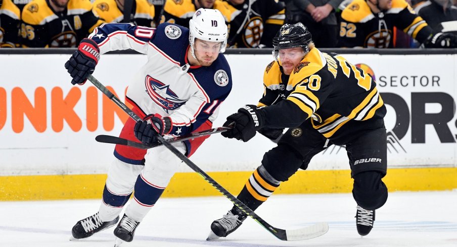 Alexander Wennberg fights for a loose puck against the Boston Bruins