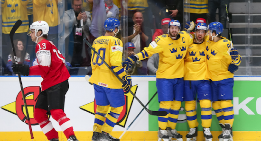 Alexander Wennberg celebrates with the rest of his Sweden teammates as they score a goal against Switzerland