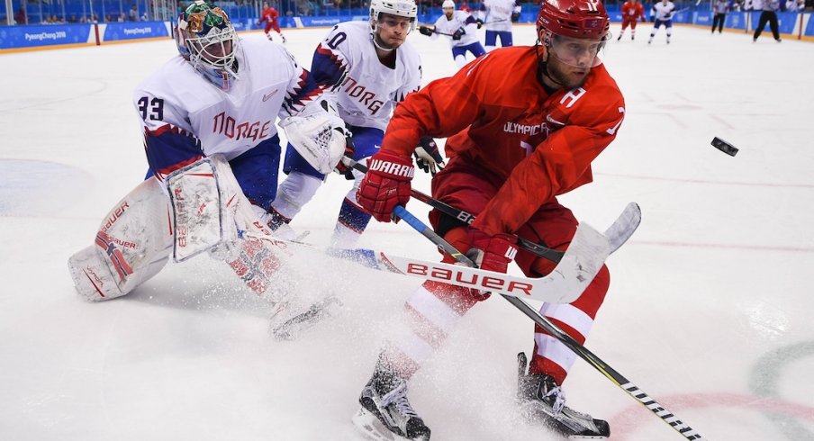 Olympic Athlete from Russia forward Sergei Andronov (11) plays the puck ahead of Norway goaltender Henrik Haukeland (33) and defenseman Mattias Norstebo (10) in the second period of the men's hockey quarterfinals during the Pyeongchang 2018 Olympic Winter Games at Gangneung Hockey Centre. 