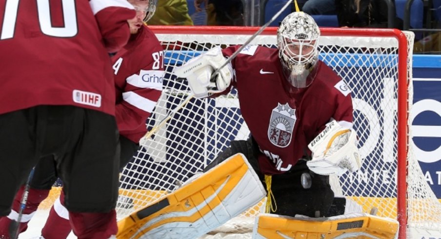 Elvis Merzlikins makes a save for Latvia at the World Championships in Slovakia