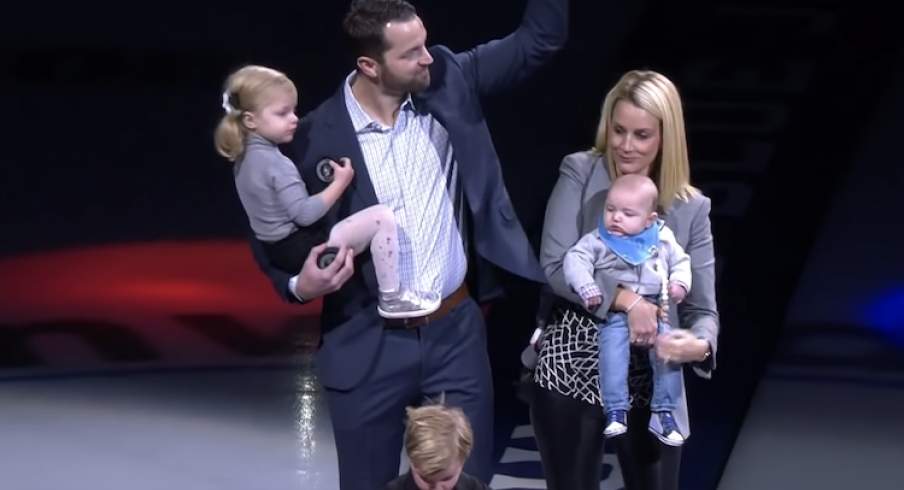 Former Columbus Blue Jackets captain Rick Nash and his wife Jessica salute the crowd at Nationwide Arena.