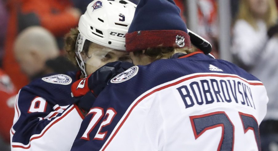 Columbus Blue Jackets forward Artemi Panarin and goaltender Sergei Bobrovsky celebrate with one another after defeating the Washington Capitals in overtime