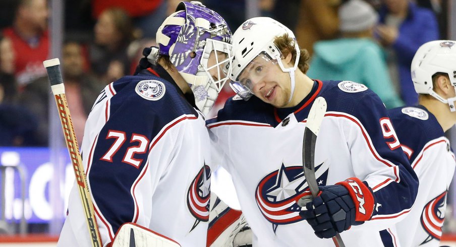 Columbus Blue Jackets goaltender Sergei Bobrovsky (72) celebrates with Blue Jackets left wing Artemi Panarin (9) after their game against the Washington Capitals at Capital One Arena.