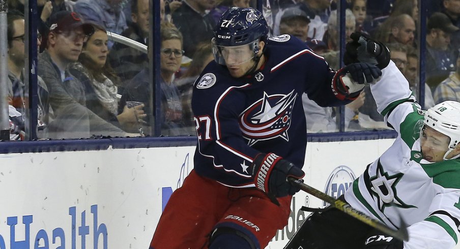 Columbus Blue Jackets defenseman Ryan Murray battles along the boards against the Dallas Stars during a game in November of 2018