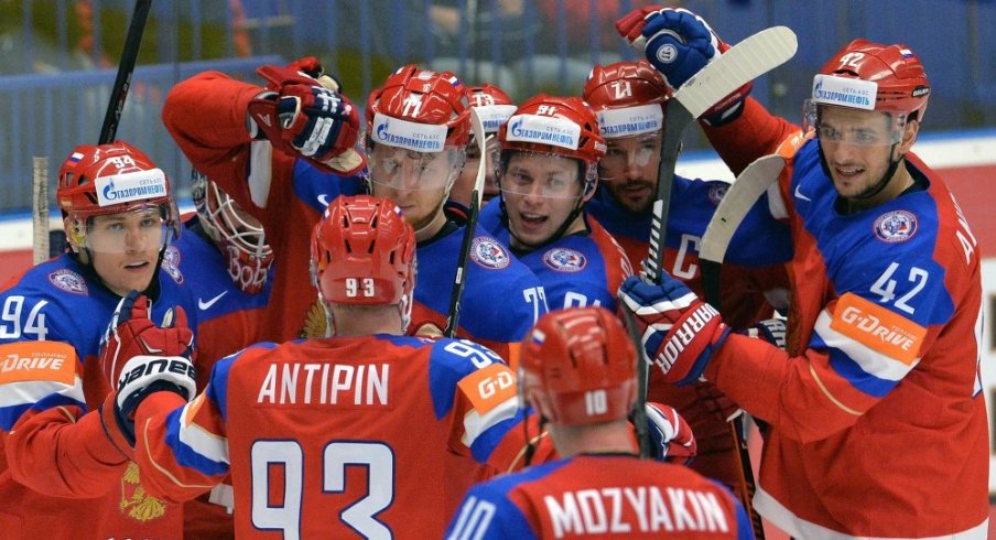 Russian forwards celebrate after scoring a goal.