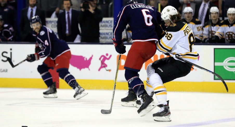 May 2, 2019; Columbus, OH, USA; Columbus Blue Jackets defenseman Adam Clendening (6) checks Boston Bruins right wing David Pastrnak (88) in the first period during game four of the second round of the 2019 Stanley Cup Playoffs at Nationwide Arena.